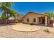 Gravel backyard with a manicured circular planter and views of the home's covered patio at 15460 W Mescal W St, Surprise, AZ 85379