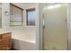 Bathroom featuring a shower, vanity, soaking tub, and a window with a privacy blind, offering both functionality and relaxation at 15460 W Mescal W St, Surprise, AZ 85379