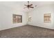 Spacious bedroom with vaulted ceiling, ceiling fan, and ample natural light from multiple windows at 15460 W Mescal W St, Surprise, AZ 85379