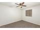 Bedroom features neutral carpet with ceiling fan and window with blinds at 15460 W Mescal W St, Surprise, AZ 85379