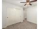 Bedroom features a ceiling fan and closet with sliding doors, designed for comfort and storage at 15460 W Mescal W St, Surprise, AZ 85379