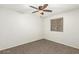 A bright bedroom, featuring a window with a security screen and a ceiling fan for added comfort at 15460 W Mescal W St, Surprise, AZ 85379