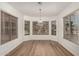 Cozy dining area with bay window, wood-look floors, and hanging light fixture at 15460 W Mescal W St, Surprise, AZ 85379
