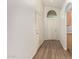 Bright entryway with wood-look floors, coat closet, and interior access door at 15460 W Mescal W St, Surprise, AZ 85379