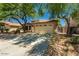 Inviting single-story home featuring desert landscaping, a two-car garage, and a spacious driveway at 15460 W Mescal W St, Surprise, AZ 85379