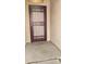 This home's covered entryway features a sturdy front door with decorative ironwork and a secure screen at 15460 W Mescal W St, Surprise, AZ 85379