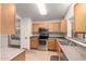 Well-equipped kitchen with stainless steel appliances and wood cabinetry at 15460 W Mescal W St, Surprise, AZ 85379