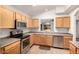 This efficiently-designed kitchen offers sleek stainless-steel appliances, ample storage, and durable flooring at 15460 W Mescal W St, Surprise, AZ 85379