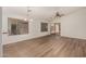 Spacious living room with wood-look floors, ceiling fan, and natural light at 15460 W Mescal W St, Surprise, AZ 85379