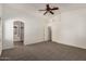 A large carpeted main bedroom that offers an ensuite bathroom and walk in closet at 15460 W Mescal W St, Surprise, AZ 85379