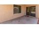 Covered patio with access to inside the home through the glass sliding doors and window at 15460 W Mescal W St, Surprise, AZ 85379