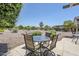Outdoor seating with table and chairs on patio with desert landscaping and clear blue skies above at 15960 W Indigo Ln, Surprise, AZ 85374