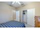 Bedroom featuring a ceiling fan, closet with sliding doors, and access to an en-suite bathroom at 15960 W Indigo Ln, Surprise, AZ 85374
