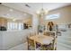 View of dining area featuring light fixture, built-in shelves, and open access to the kitchen and stainless steel appliances at 15960 W Indigo Ln, Surprise, AZ 85374