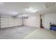 Spacious three car garage with bright lighting and built-in storage cabinets at 15960 W Indigo Ln, Surprise, AZ 85374