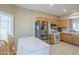 View of kitchen, with stainless steel appliances, light wood cabinets, and marble countertop seating at 15960 W Indigo Ln, Surprise, AZ 85374