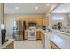 Spacious kitchen with stainless steel appliances and white countertops, offering ample natural light at 15960 W Indigo Ln, Surprise, AZ 85374