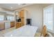 Bright kitchen with a marble kitchen island, a coffee bar, and light wood cabinetry at 15960 W Indigo Ln, Surprise, AZ 85374