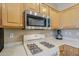 Close-up of kitchen with gas range, stainless steel microwave, and plenty of counter space at 15960 W Indigo Ln, Surprise, AZ 85374