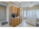 Bright kitchen featuring wood cabinets, white countertops, and a built-in kitchen island with seating at 15960 W Indigo Ln, Surprise, AZ 85374