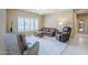 Comfortable living room with neutral carpeting, plantation shutters, and relaxed seating at 15960 W Indigo Ln, Surprise, AZ 85374