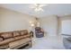 Cozy living room featuring a leather sofa, recliner, neutral decor, and tile flooring at 15960 W Indigo Ln, Surprise, AZ 85374