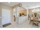 Open concept area featuring a kitchen, dining area, and entryway with light colored walls and tile flooring at 15960 W Indigo Ln, Surprise, AZ 85374