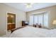 Comfortable main bedroom boasts a bay window, ceiling fan and adjacent bathroom at 15960 W Indigo Ln, Surprise, AZ 85374