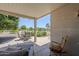 Enjoy outdoor dining in this spacious covered patio with seating for four people at 15960 W Indigo Ln, Surprise, AZ 85374