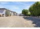 Expansive gravel backyard with mature landscaping and access to rear buildings at 16645 W Papago St, Goodyear, AZ 85338