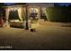 Backyard pergola adorned with lights and curtains, creating a relaxing outdoor retreat with lush landscaping at 16645 W Papago St, Goodyear, AZ 85338