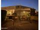 Home's exterior shows a manicured backyard with patio furniture and a pergola, perfect for outdoor living at 16645 W Papago St, Goodyear, AZ 85338