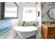 Bright bathroom with freestanding tub, elegant fixtures, and decor at 16645 W Papago St, Goodyear, AZ 85338