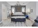 Spacious bedroom features a wrought iron chandelier, plush bedding, and light gray walls at 16645 W Papago St, Goodyear, AZ 85338