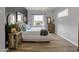 Cozy bedroom with dark accent wall, hardwood floors, and unique bedside tables at 16645 W Papago St, Goodyear, AZ 85338