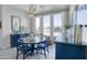 Well-lit dining room boasts a blue accent cabinet, pendant lighting, and views of the exterior at 16645 W Papago St, Goodyear, AZ 85338