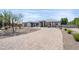 Beautiful single-story home featuring a paver driveway and desert landscaping in a sunny setting at 16645 W Papago St, Goodyear, AZ 85338