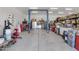 Functional garage with auto lift, storage racks, and ample space for projects and vehicle maintenance at 16645 W Papago St, Goodyear, AZ 85338
