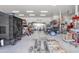 Spacious garage featuring multiple storage solutions, tools, equipment and open workspace at 16645 W Papago St, Goodyear, AZ 85338