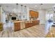 Open kitchen with wood cabinets, a large island, and a view into the living room at 16645 W Papago St, Goodyear, AZ 85338