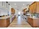 Spacious kitchen with wooden cabinetry, stainless steel appliances, and granite countertops at 16645 W Papago St, Goodyear, AZ 85338