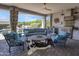 Covered patio offers comfortable seating, an outdoor kitchen, and views of the lush backyard at 16645 W Papago St, Goodyear, AZ 85338