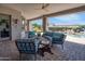 Beautiful covered patio with cozy seating, ceiling fan, and views of the pool and landscaping at 16645 W Papago St, Goodyear, AZ 85338