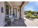 Covered patio with brick flooring, comfortable seating, and views of lush outdoor decor at 16645 W Papago St, Goodyear, AZ 85338