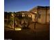 Charming backyard pergola with string lights, creating a cozy outdoor seating area and landscaping at 16645 W Papago St, Goodyear, AZ 85338