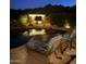 Inviting poolside cabana with draped curtains and lounge chairs with a tranquil setting for outdoor relaxation at 16645 W Papago St, Goodyear, AZ 85338