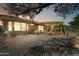 Backyard with a covered patio, desert landscaping, and gravel, perfect for relaxing outdoors at 16857 W Villagio Dr, Surprise, AZ 85387