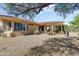 Spacious backyard with a covered patio, desert landscaping, and gravel for easy upkeep at 16857 W Villagio Dr, Surprise, AZ 85387