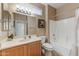 This bathroom features tan walls, a shower and tub, and a framed picture at 16857 W Villagio Dr, Surprise, AZ 85387