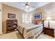 Cozy bedroom with neutral carpet, ceiling fan, and wood furniture at 16857 W Villagio Dr, Surprise, AZ 85387